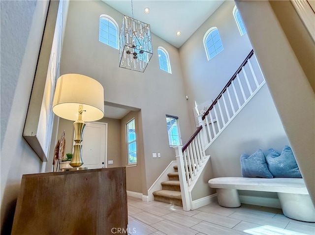 6184 Lafayette St, Chino, CA 91710 - foyer entrance featuring stairway, a chandelier, baseboards, a high ceiling, and recessed lighting