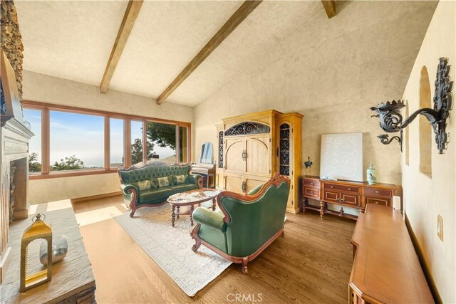 1465 Via Coronel, Palos Verdes Estates, CA 90274 - living room featuring wood finished floors, beamed ceiling, high vaulted ceiling, and a fireplace with raised hearth