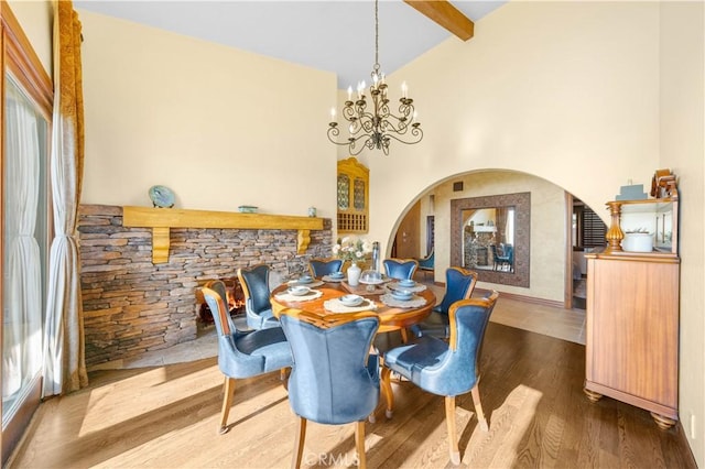 1465 Via Coronel, Palos Verdes Estates, CA 90274 - dining area featuring arched walkways, beamed ceiling, wood finished floors, a chandelier, and high vaulted ceiling
