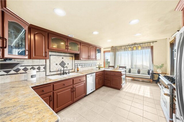 1465 Via Coronel, Palos Verdes Estates, CA 90274 - kitchen with stainless steel stove, a sink, white dishwasher, backsplash, and light tile patterned floors