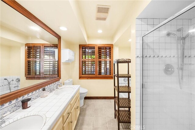 1465 Via Coronel, Palos Verdes Estates, CA 90274 - bathroom featuring toilet, double vanity, a shower stall, baseboards, and tile patterned floors