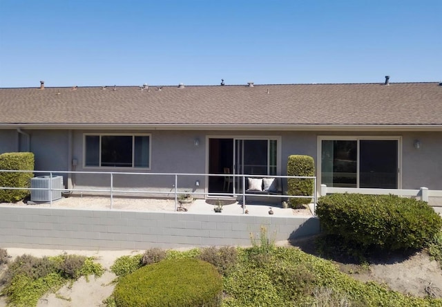 3625 Vista Oceana Unit 18, Oceanside, CA 92057 - rear view of property featuring stucco siding, central air condition unit, and roof with shingles