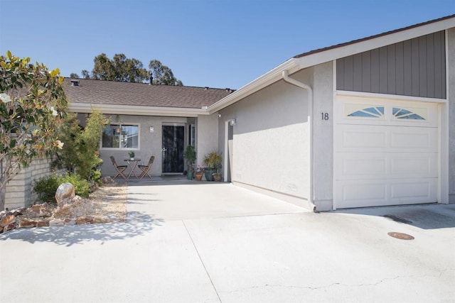 3625 Vista Oceana Unit 18, Oceanside, CA 92057 - view of front of house with a garage, stucco siding, and driveway