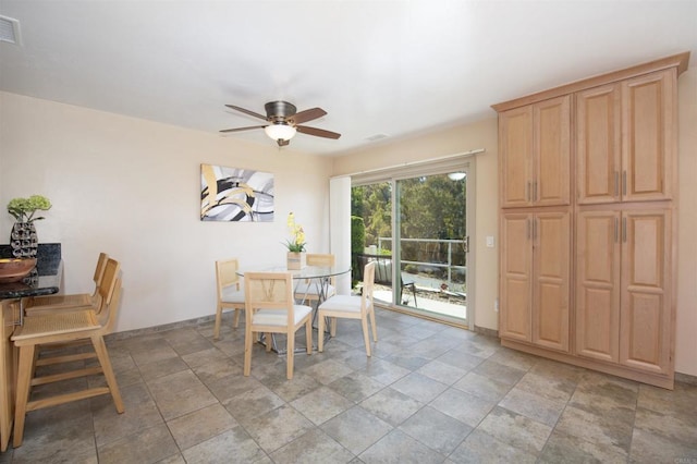 3625 Vista Oceana Unit 18, Oceanside, CA 92057 - dining area featuring ceiling fan, stone finish flooring, and baseboards