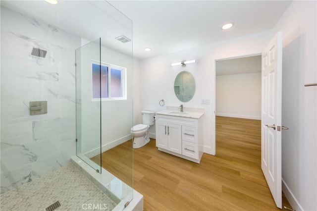 22016 Schoolcraft St, Canoga Park, CA 91303 - bathroom with a marble finish shower, toilet, vanity, wood finished floors, and recessed lighting