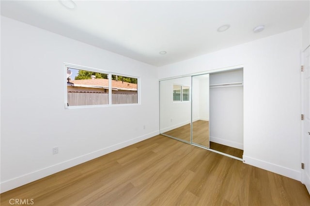 22016 Schoolcraft St, Canoga Park, CA 91303 - unfurnished bedroom with wood finished floors, baseboards, and a closet