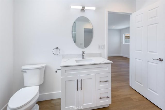 22016 Schoolcraft St, Canoga Park, CA 91303 - bathroom featuring toilet, baseboards, vanity, and wood finished floors