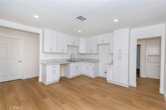 22016 Schoolcraft St, Canoga Park, CA 91303 - kitchen featuring a sink, light wood finished floors, baseboards, white cabinetry, and recessed lighting