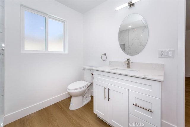 22016 Schoolcraft St, Canoga Park, CA 91303 - bathroom featuring wood finished floors, toilet, vanity, a marble finish shower, and baseboards
