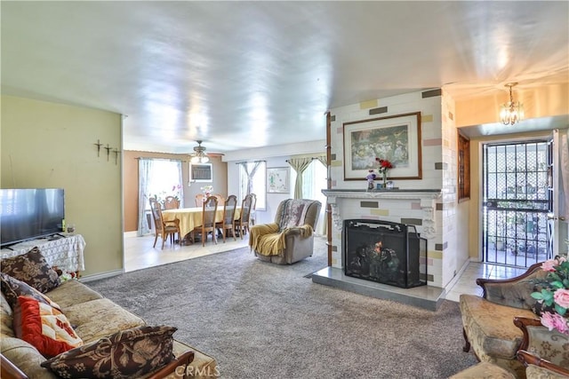 1706 James Pl, Pomona, CA 91767 - living room featuring a warm lit fireplace, baseboards, a chandelier, carpet, and a ceiling fan