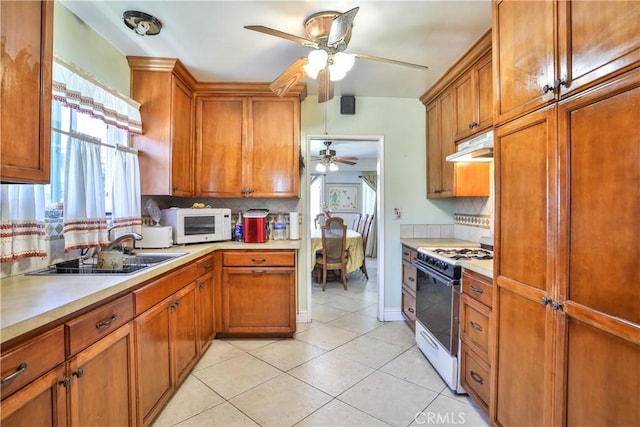 1706 James Pl, Pomona, CA 91767 - kitchen with white appliances, a ceiling fan, decorative backsplash, and light countertops