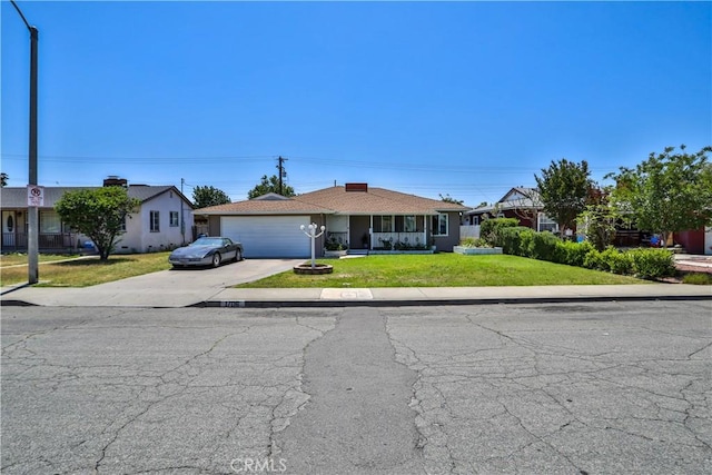 1706 James Pl, Pomona, CA 91767 - ranch-style home with concrete driveway, a front lawn, an attached garage, and covered porch