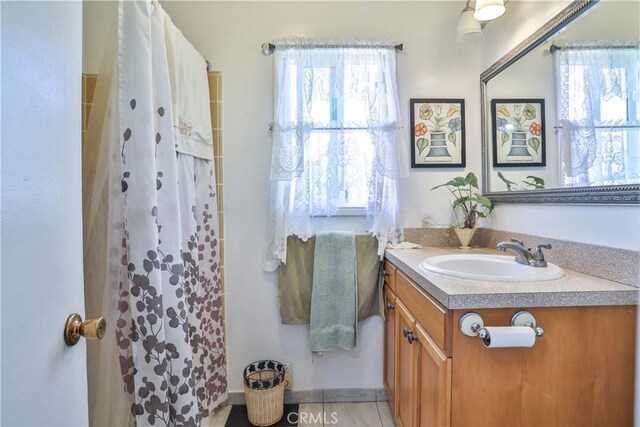 1706 James Pl, Pomona, CA 91767 - bathroom featuring vanity, a shower with curtain, and tile patterned floors