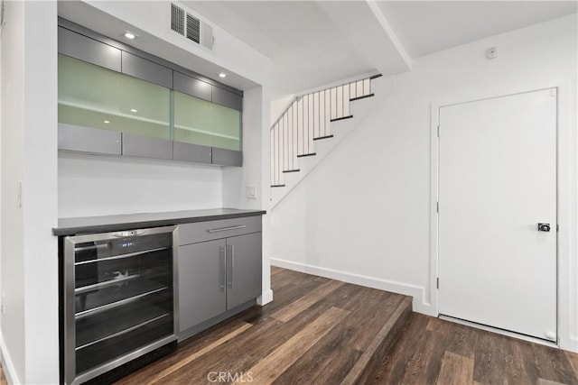 18653 Burbank Blvd Unit 2, Tarzana, CA 91356 - indoor dry bar featuring beverage cooler, dark wood-type flooring, stairway, and baseboards