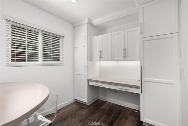 18653 Burbank Blvd Unit 2, Tarzana, CA 91356 - unfurnished office featuring dark wood-type flooring, baseboards, built in study area, and ornamental molding