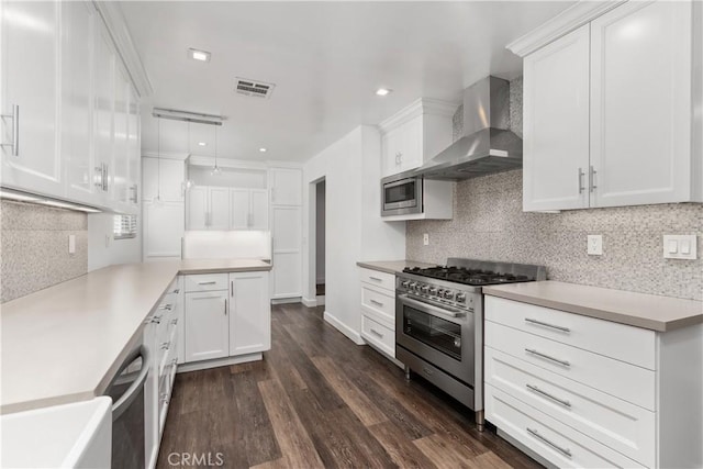 18653 Burbank Blvd Unit 2, Tarzana, CA 91356 - kitchen with appliances with stainless steel finishes, wall chimney exhaust hood, dark wood-style flooring, tasteful backsplash, and recessed lighting