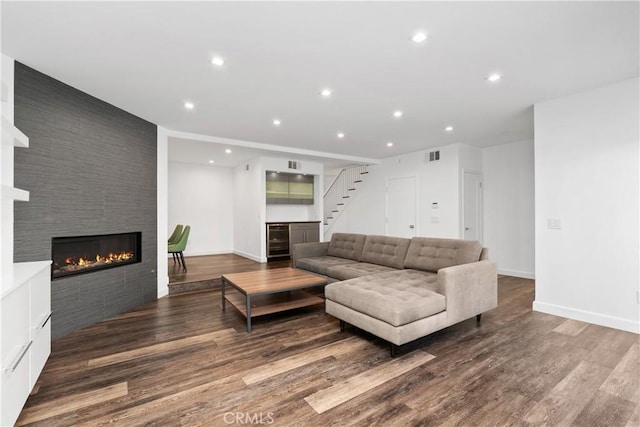 18653 Burbank Blvd Unit 2, Tarzana, CA 91356 - living area featuring wine cooler, a large fireplace, wood finished floors, recessed lighting, and stairs