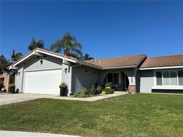 7025 Palm Dr, Rancho Cucamonga, CA 91701 - ranch-style house with stucco siding, a tiled roof, an attached garage, a front lawn, and driveway