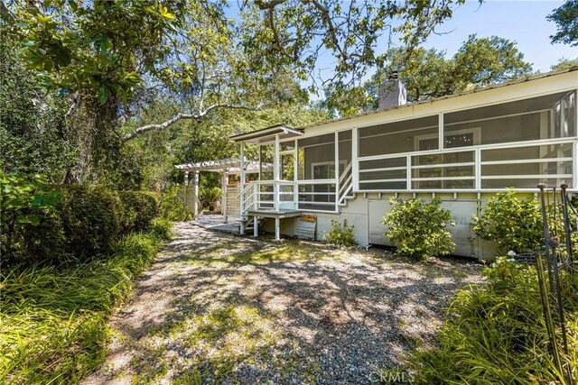 29422 Modjeska Canyon Rd, Modjeska Canyon, CA 92676 - back of house with a sunroom, a pergola, and a chimney