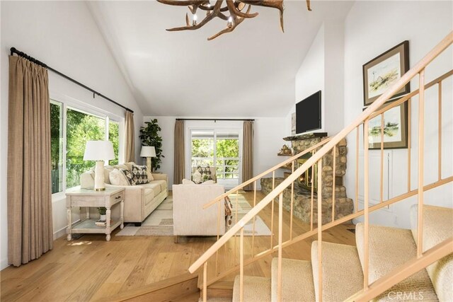 29422 Modjeska Canyon Rd, Modjeska Canyon, CA 92676 - stairway with wood finished floors, high vaulted ceiling, and a chandelier