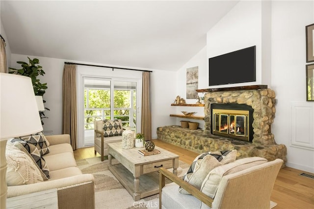 29422 Modjeska Canyon Rd, Modjeska Canyon, CA 92676 - living room featuring vaulted ceiling, wood finished floors, and a fireplace