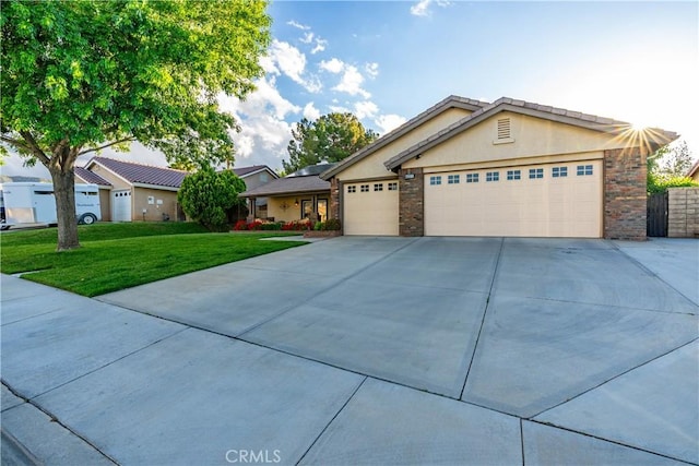 42311 Camden Way, Lancaster, CA 93536 - single story home with driveway, a front lawn, a garage, and stucco siding