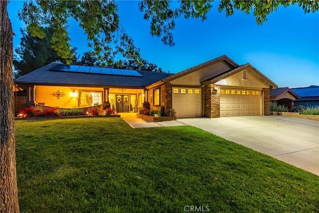 42311 Camden Way, Lancaster, CA 93536 - ranch-style house with an attached garage, driveway, solar panels, and a front yard
