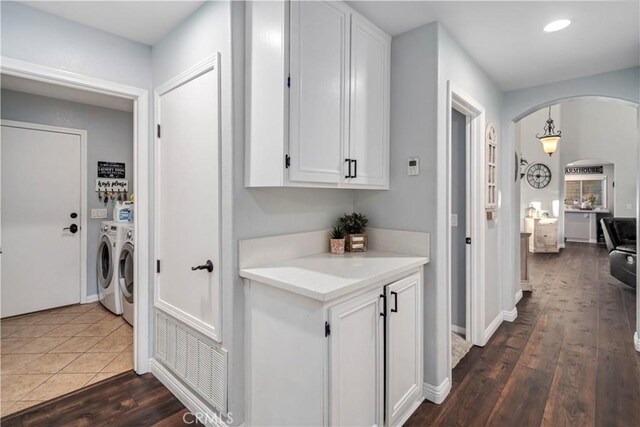 42311 Camden Way, Lancaster, CA 93536 - laundry room with washing machine and clothes dryer, arched walkways, wood finished floors, recessed lighting, and cabinet space