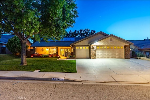42311 Camden Way, Lancaster, CA 93536 - single story home with an attached garage, solar panels, a front lawn, driveway, and brick siding