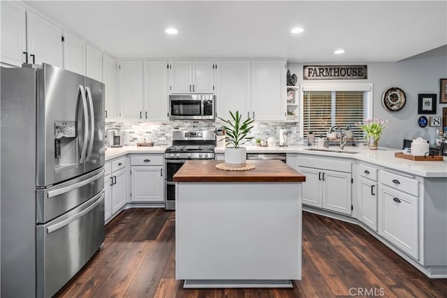 42311 Camden Way, Lancaster, CA 93536 - kitchen featuring appliances with stainless steel finishes, butcher block countertops, a sink, white cabinetry, and a kitchen island