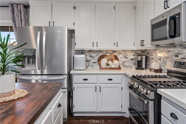 42311 Camden Way, Lancaster, CA 93536 - kitchen with stainless steel appliances, wooden counters, backsplash, and white cabinetry