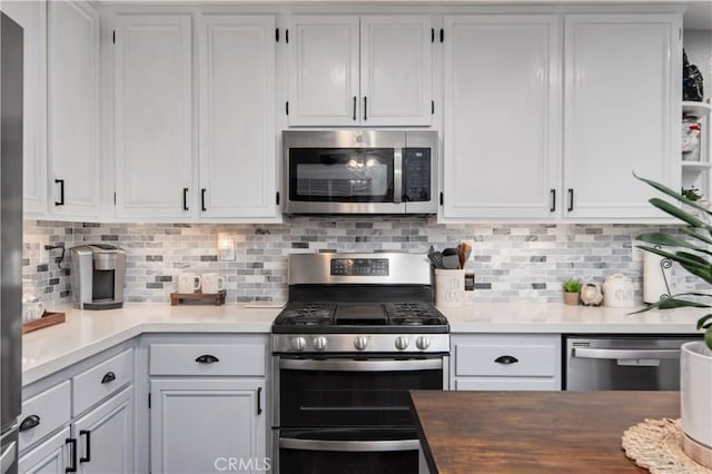 42311 Camden Way, Lancaster, CA 93536 - kitchen with appliances with stainless steel finishes, white cabinetry, tasteful backsplash, and open shelves