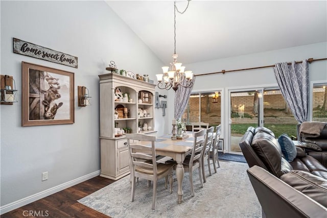 42311 Camden Way, Lancaster, CA 93536 - dining space featuring wood finished floors, a chandelier, vaulted ceiling, and baseboards