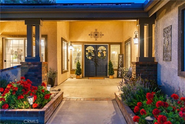 42311 Camden Way, Lancaster, CA 93536 - doorway to property featuring stucco siding and covered porch