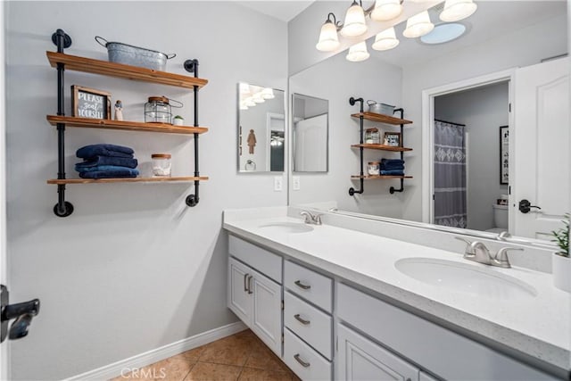 42311 Camden Way, Lancaster, CA 93536 - bathroom featuring double vanity, baseboards, tile patterned floors, and toilet