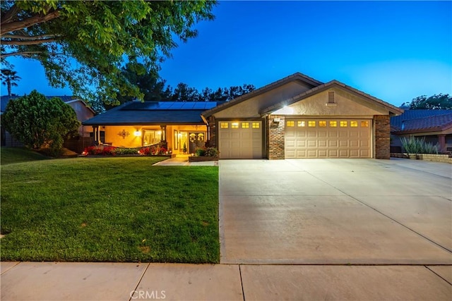 42311 Camden Way, Lancaster, CA 93536 - single story home featuring an attached garage, a front yard, roof mounted solar panels, driveway, and stucco siding