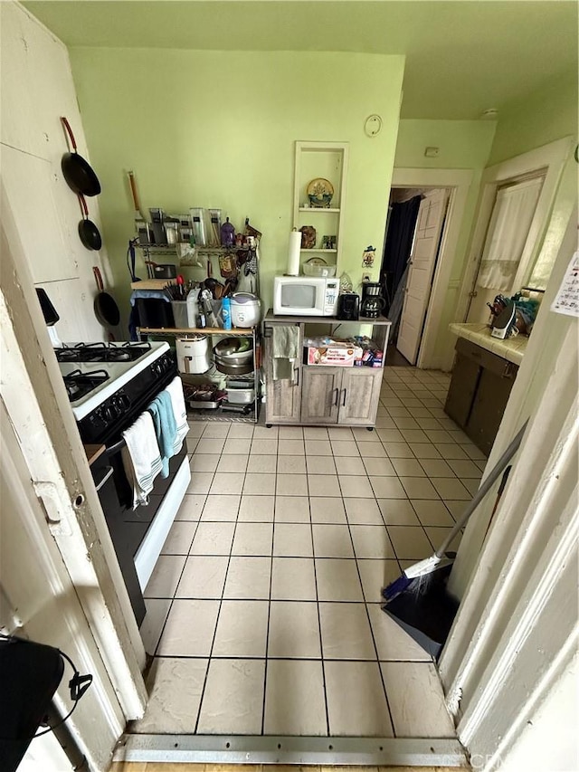 415417 Euclid Ave, Los Angeles, CA 90063 - kitchen with white microwave, light tile patterned floors, and gas range