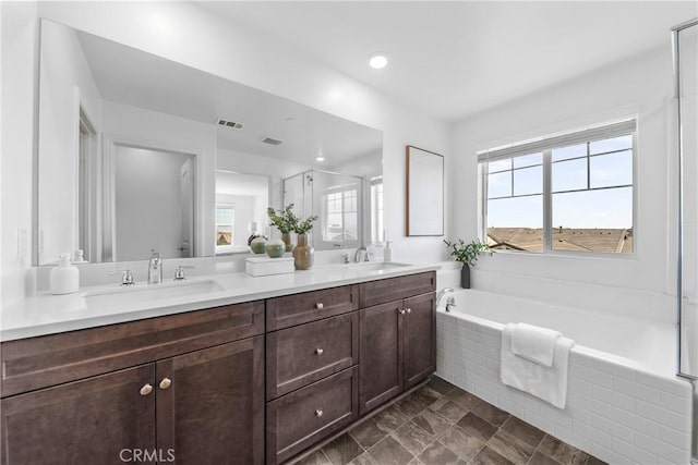 16725 Petrus Ln, Fontana, CA 92336 - bathroom featuring healthy amount of natural light, a garden tub, double vanity, and a shower stall