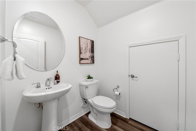 16725 Petrus Ln, Fontana, CA 92336 - half bathroom with toilet, lofted ceiling, wood finished floors, baseboards, and a sink