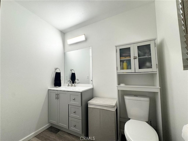 7425 I Ave, Hesperia, CA 92345 - bathroom with toilet, wood finished floors, vanity, and baseboards