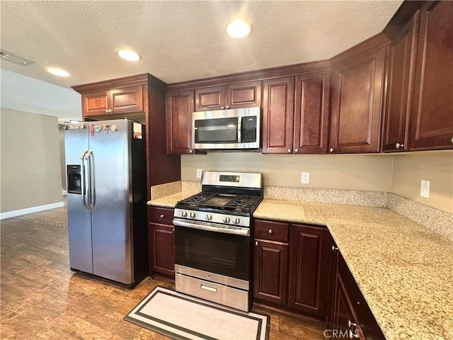 7425 I Ave, Hesperia, CA 92345 - kitchen featuring stainless steel appliances, recessed lighting, a textured ceiling, baseboards, and light stone counters