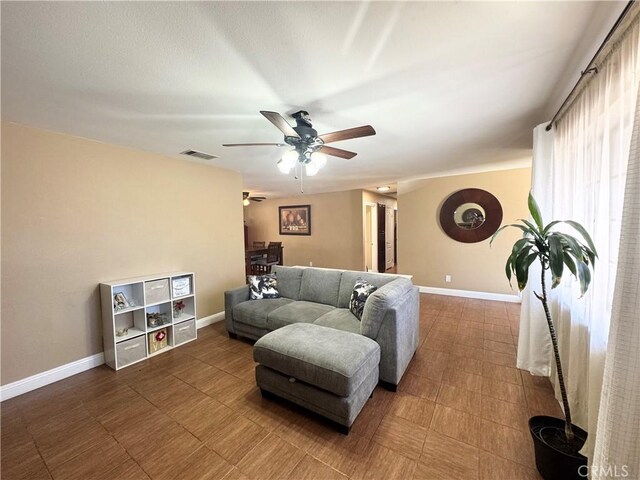 7425 I Ave, Hesperia, CA 92345 - living room featuring a ceiling fan and baseboards