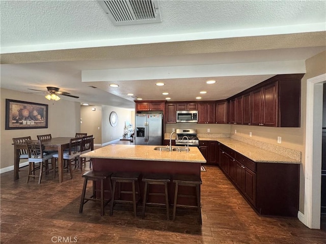 7425 I Ave, Hesperia, CA 92345 - kitchen with appliances with stainless steel finishes, dark wood-style flooring, baseboards, a breakfast bar area, and recessed lighting