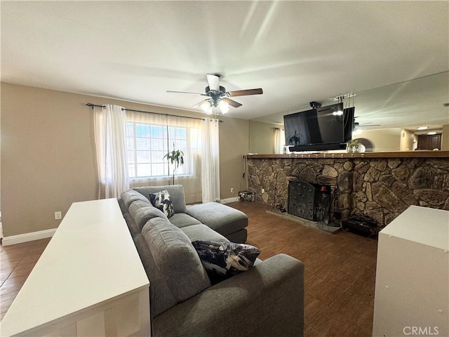 7425 I Ave, Hesperia, CA 92345 - living area with ceiling fan, a fireplace, and baseboards
