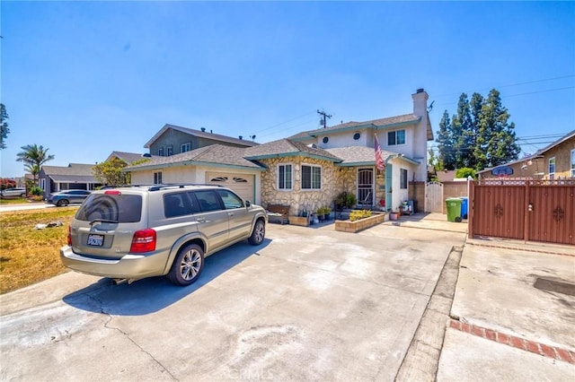 9419 Bartley Ave, Santa Fe Springs, CA 90670 - view of front of house featuring concrete driveway, a gate, and a chimney