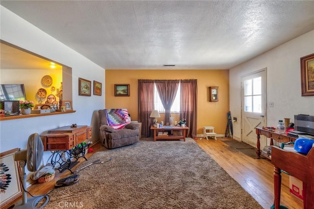 9419 Bartley Ave, Santa Fe Springs, CA 90670 - living area featuring plenty of natural light, wood finished floors, and a textured ceiling