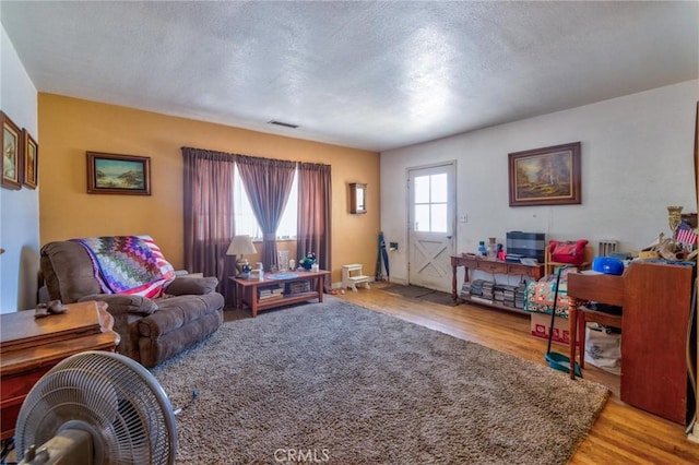 9419 Bartley Ave, Santa Fe Springs, CA 90670 - living room featuring a textured ceiling and light wood-type flooring