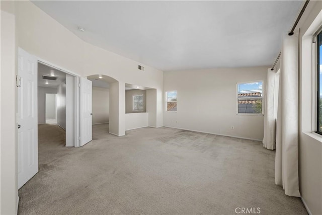 8840 Greenlawn St, Riverside, CA 92508 - empty room with light carpet, arched walkways, and baseboards