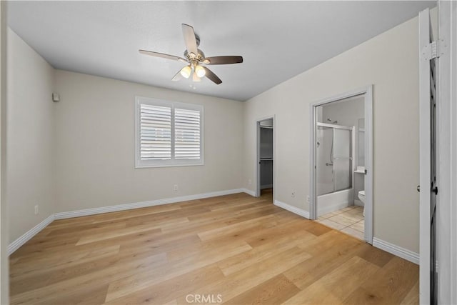 8840 Greenlawn St, Riverside, CA 92508 - unfurnished bedroom with light wood finished floors, a walk in closet, ensuite bath, a closet, and a ceiling fan
