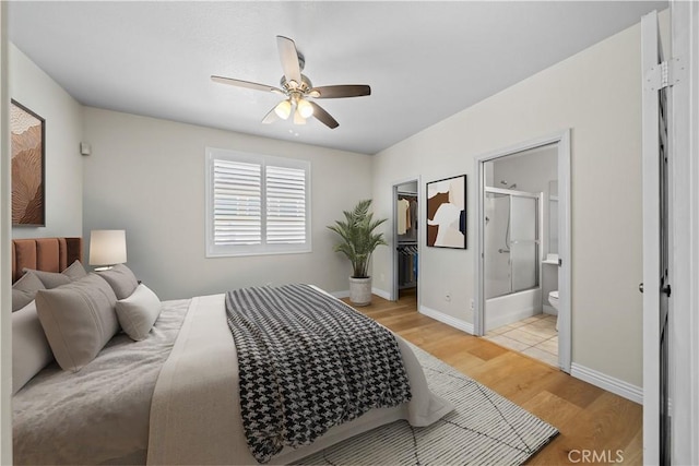 8840 Greenlawn St, Riverside, CA 92508 - bedroom featuring light wood-style floors, a walk in closet, ensuite bath, a closet, and a ceiling fan